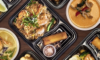 Assorted Asian catering trays with stir-fried noodles, rice and dumplings