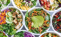 Healthy catering bowls with grains, roasted vegetables and greens