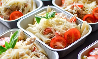 Italian catering trays of baked pasta, garlic bread and salad
